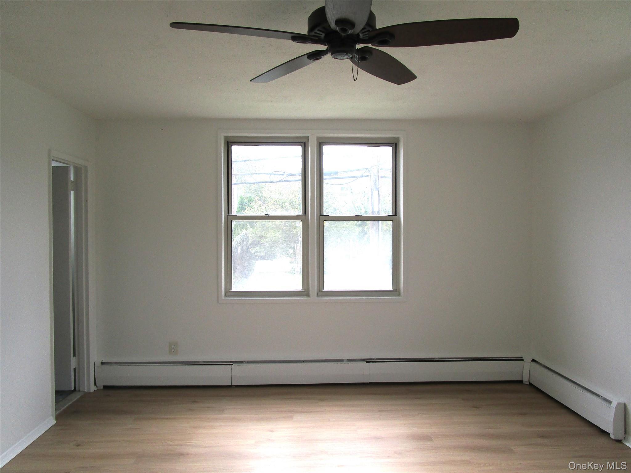 75 Noble Street, Unit 126 Lynbrook, NY 11563 - Photo 27 of 36 an empty room with a window