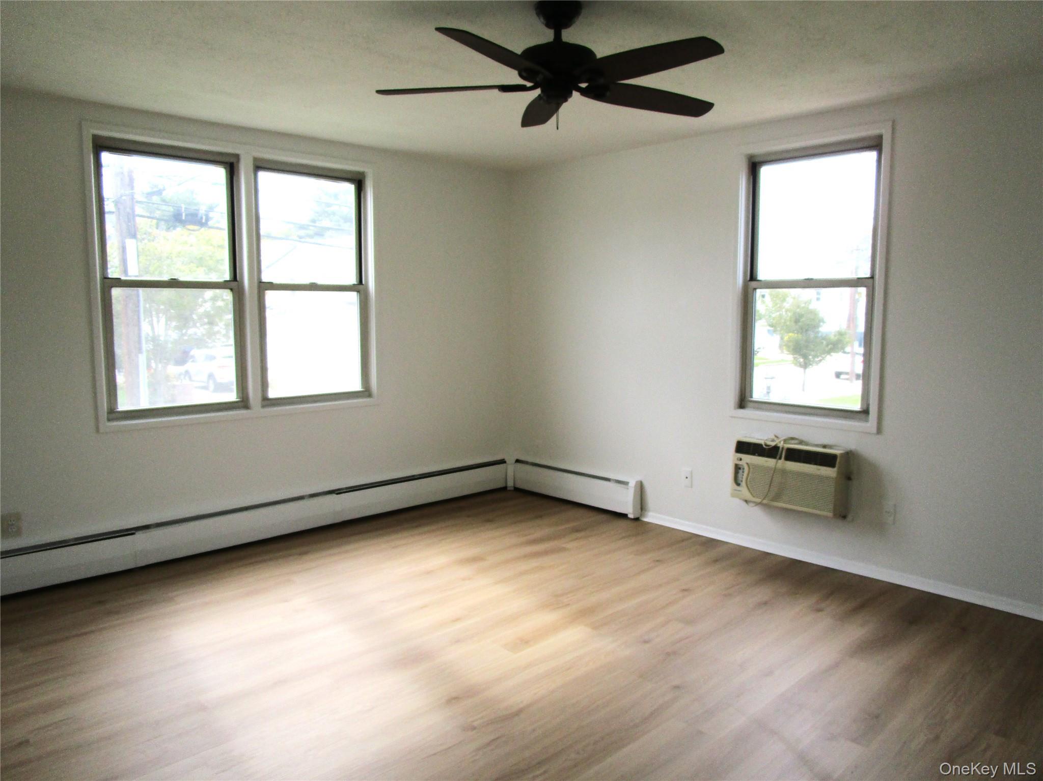 75 Noble Street, Unit 126 Lynbrook, NY 11563 - Photo 32 of 36 an empty room with a window