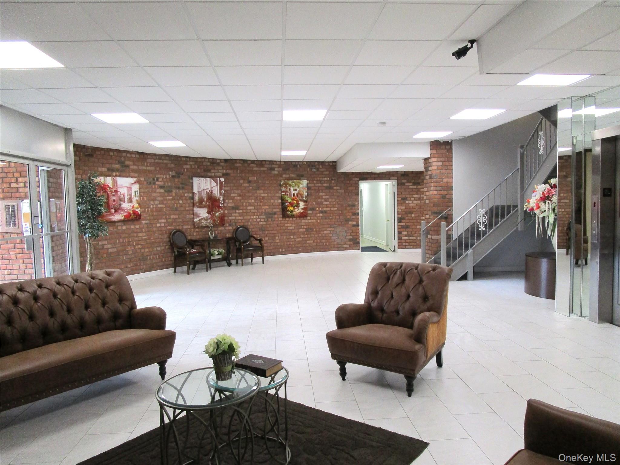 75 Noble Street, Unit 126 Lynbrook, NY 11563 - Photo 4 of 36 a living room with furniture and a couch