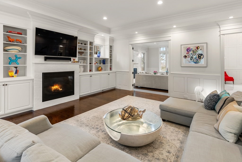 25 Sheffield Road Newton, MA 02460 - Photo 8 of 39 a living room with furniture a flat screen tv and a fireplace
