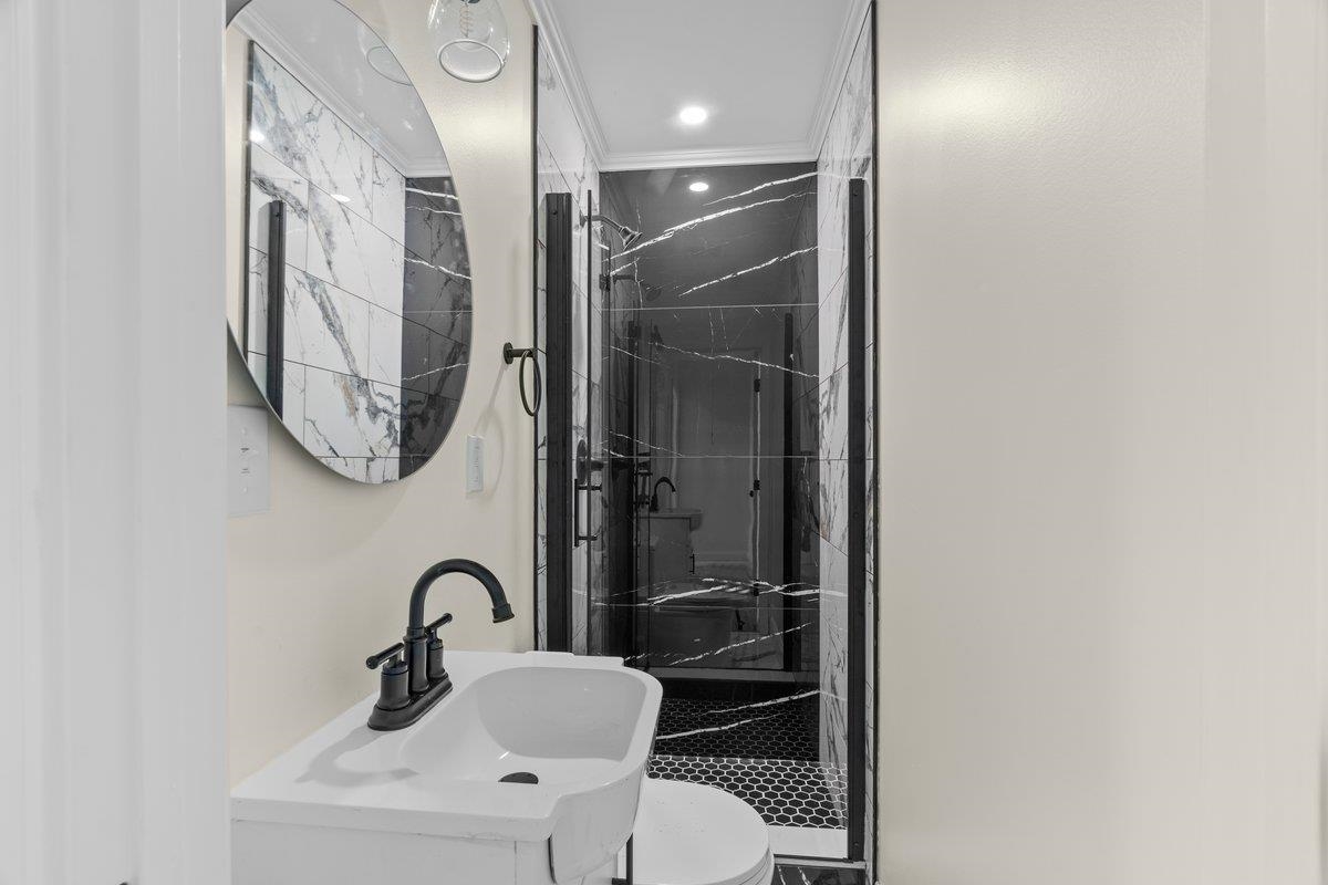 3607 Vanuys Road Memphis, TN 38111 - Photo 13 of 26 a bathroom with a toilet a sink and mirror