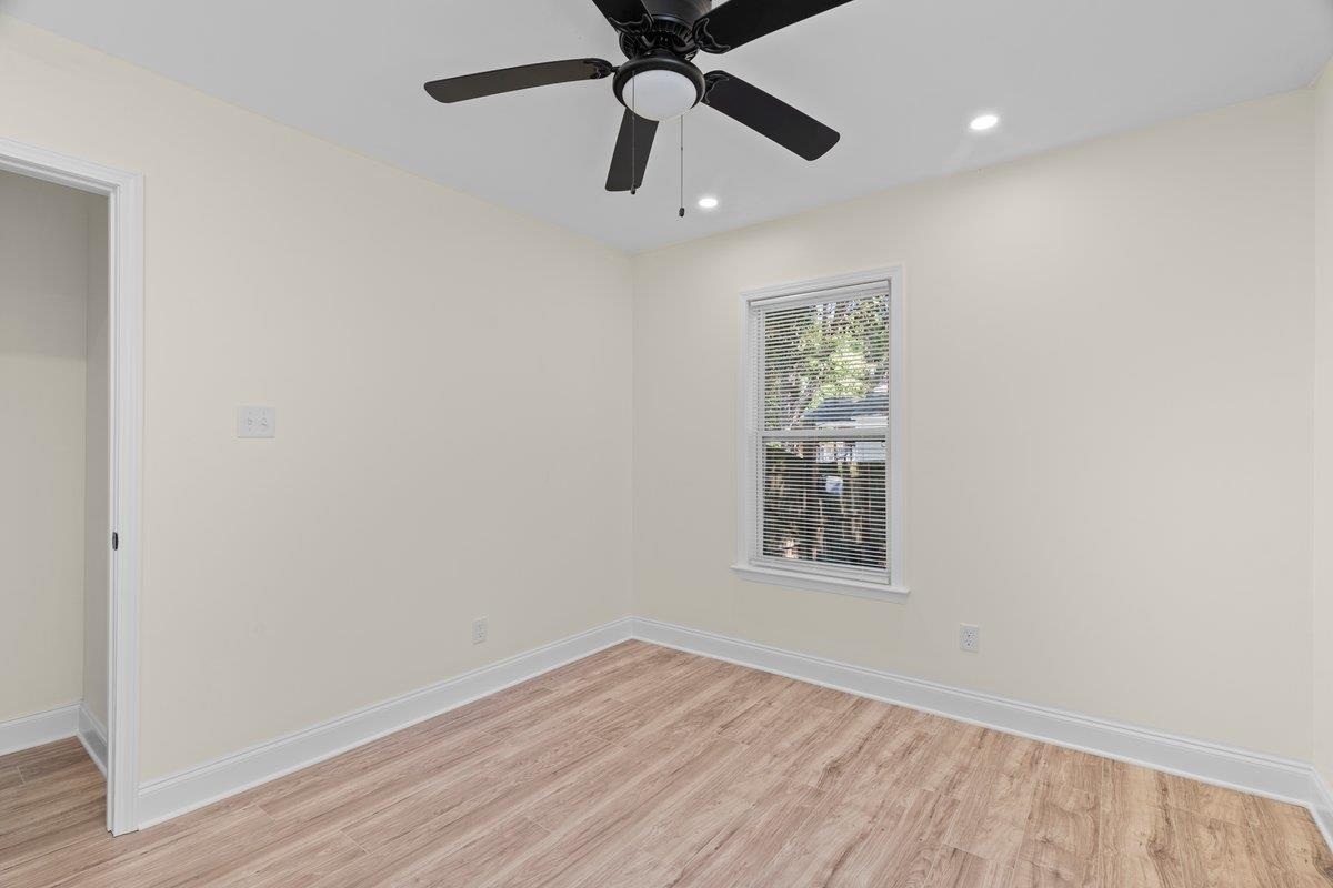 3607 Vanuys Road Memphis, TN 38111 - Photo 18 of 26 an empty room with wooden floor ceiling fan and windows