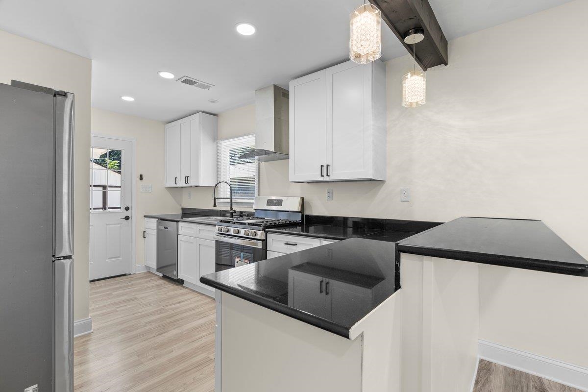 3607 Vanuys Road Memphis, TN 38111 - Photo 6 of 26 a kitchen with stainless steel appliances granite countertop a sink and a stove