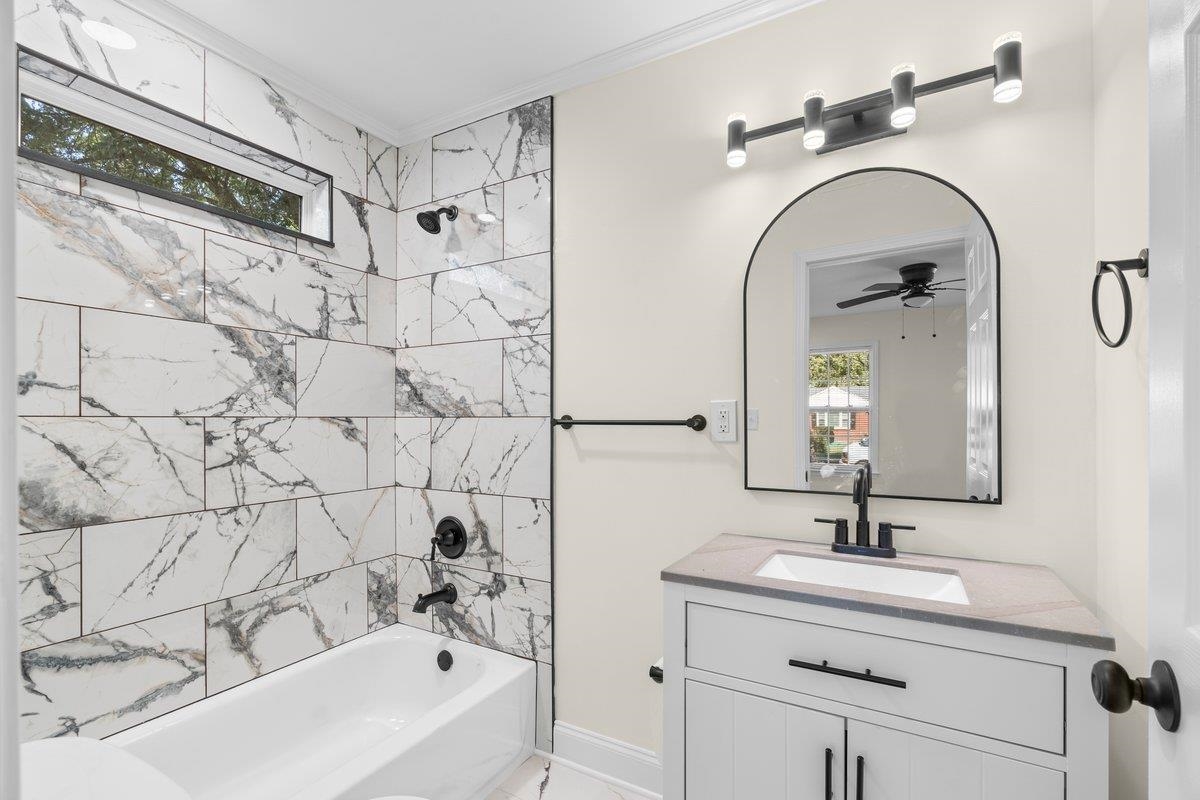 3607 Vanuys Road Memphis, TN 38111 - Photo 10 of 26 a bathroom with a sink a mirror and a bathtub