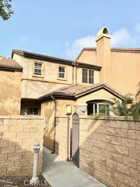 8692 East 9th Street, Unit 56 Rancho Cucamonga, CA 91730 - Photo 5 of 34 a front view of a house with garage