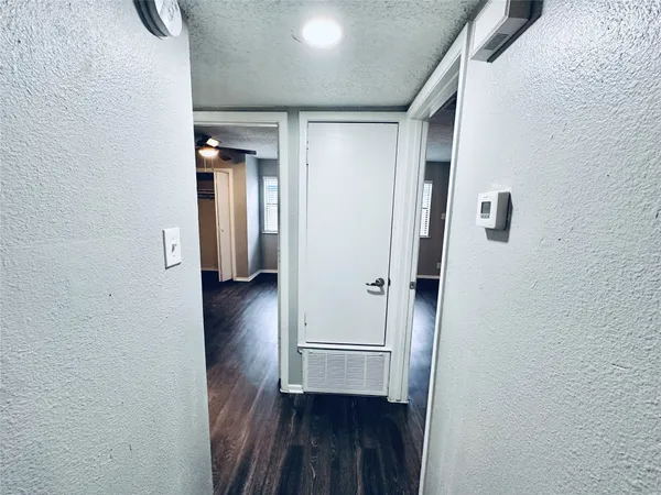 a view of hallway with wooden floor