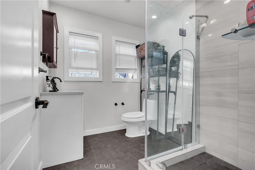 4610 Leonis Street Commerce, CA 90040 - Photo 11 of 32 a bathroom with a toilet sink and shower