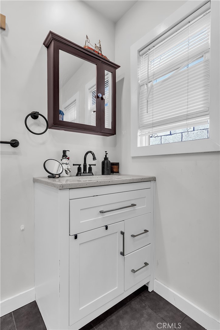 4610 Leonis Street Commerce, CA 90040 - Photo 12 of 32 a bathroom with a sink vanity and mirror