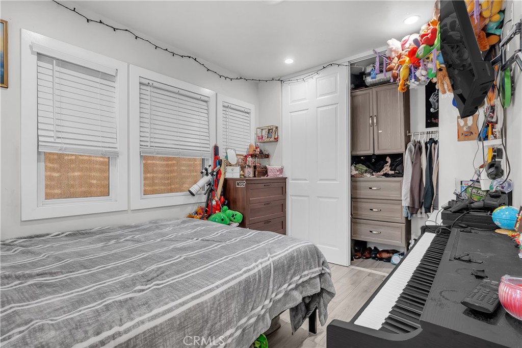4610 Leonis Street Commerce, CA 90040 - Photo 14 of 32 a bedroom with a bed closet and flat tv screen