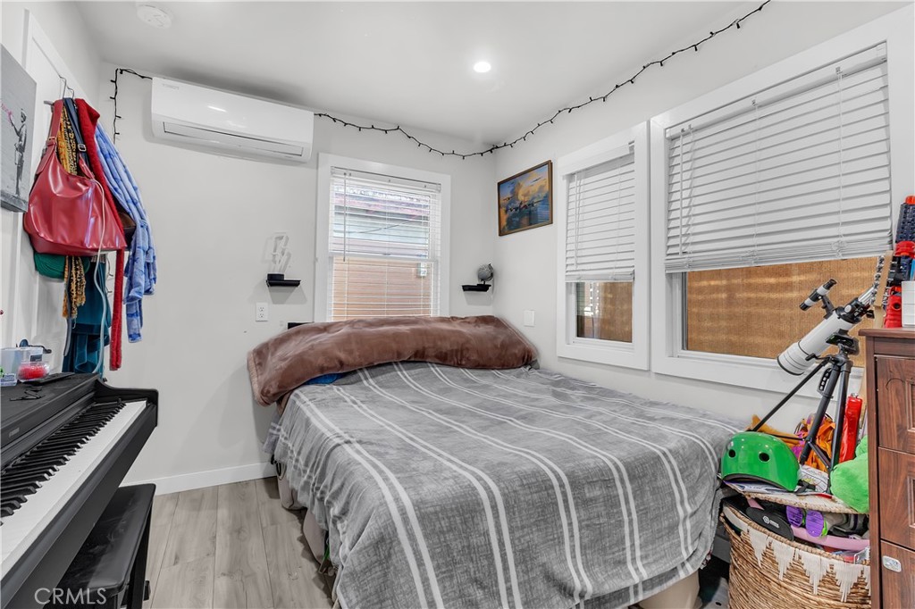 4610 Leonis Street Commerce, CA 90040 - Photo 15 of 32 a bedroom with a bed and a flat screen tv