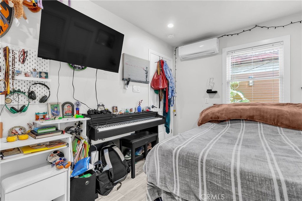 4610 Leonis Street Commerce, CA 90040 - Photo 16 of 32 a bedroom with a bed and a flat tv screen