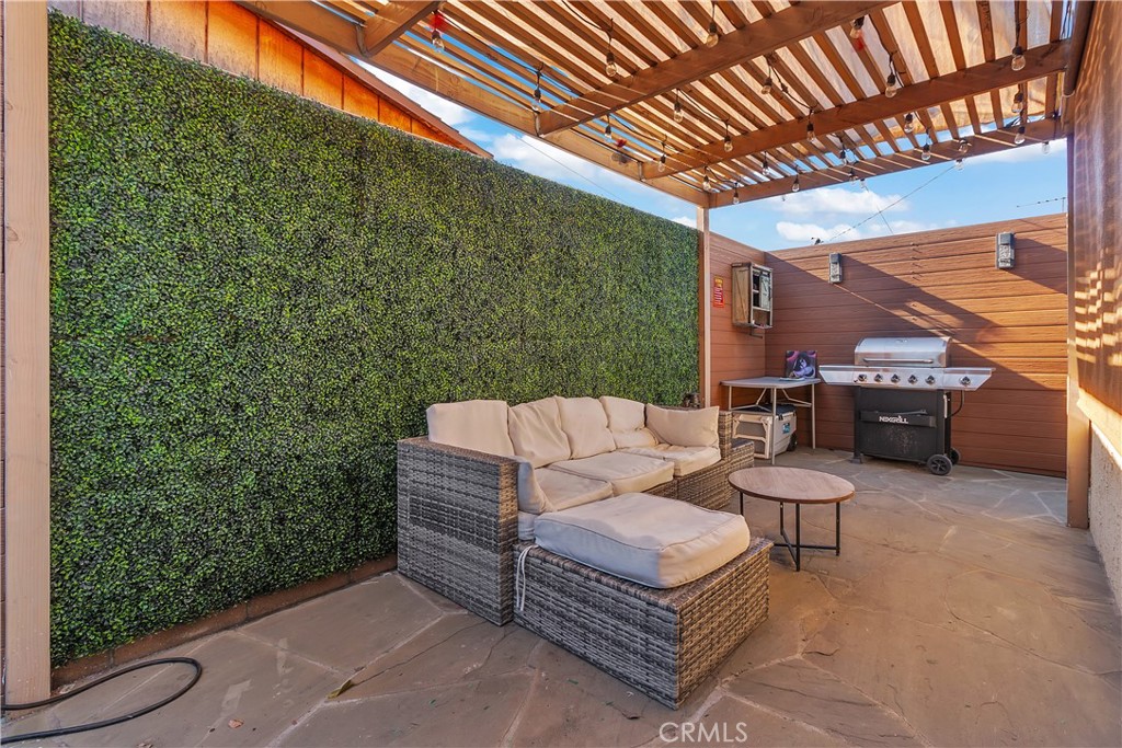 4610 Leonis Street Commerce, CA 90040 - Photo 18 of 32 a outdoor living space with furniture and a fireplace