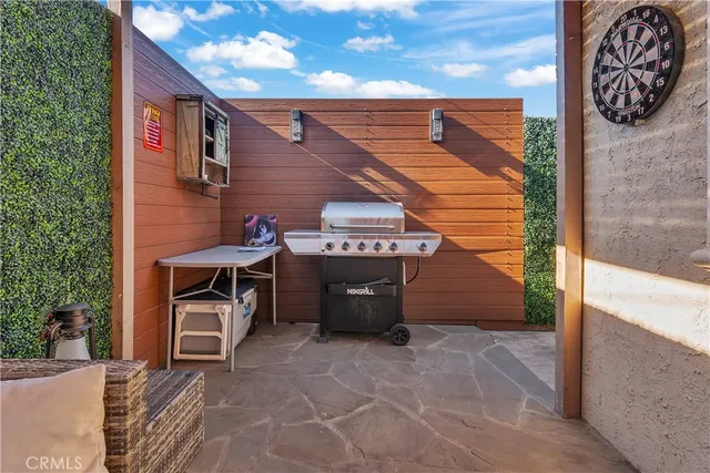 a view of a patio with a table and chairs