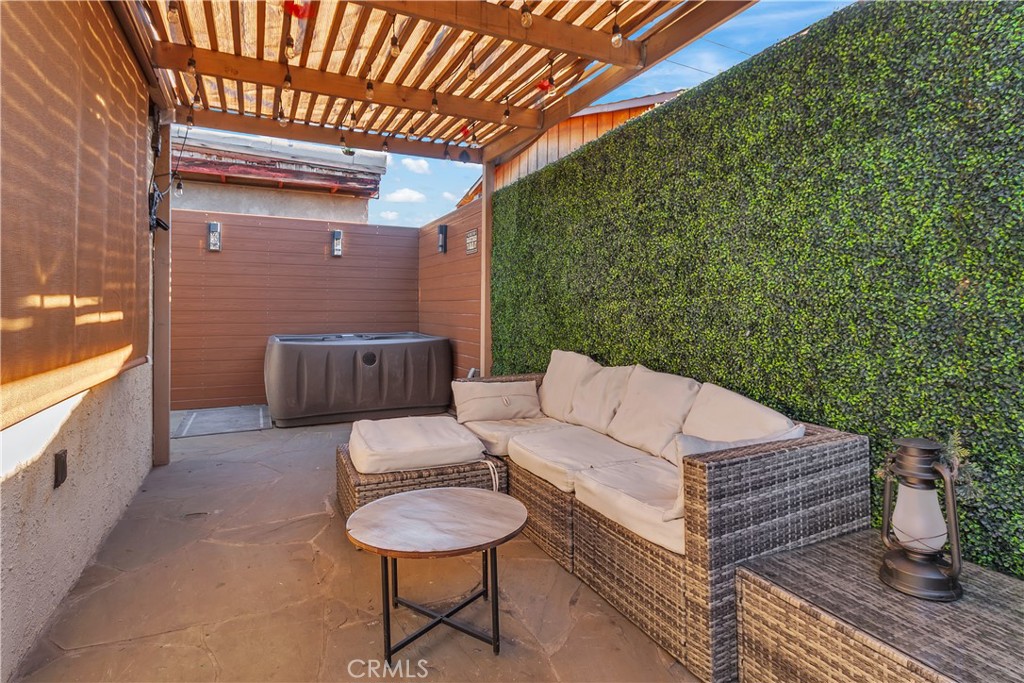 4610 Leonis Street Commerce, CA 90040 - Photo 20 of 32 a balcony with furniture and wooden floor