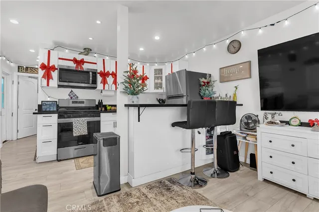 a kitchen with stainless steel appliances kitchen island granite countertop a stove and cabinets