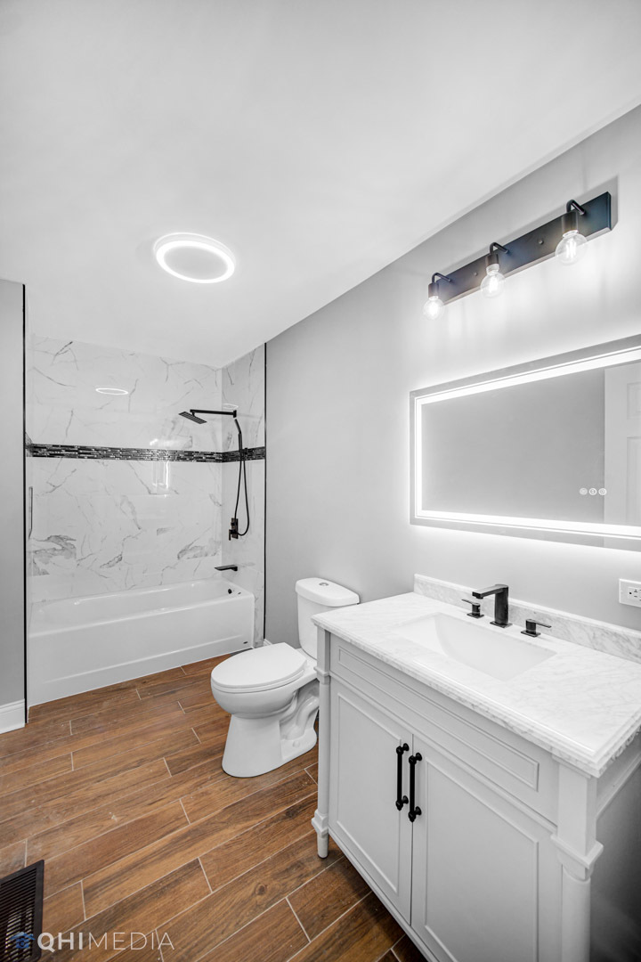 14601 Des Plaines Street Harvey, IL 60426 - Photo 12 of 21 a bathroom with a sink a toilet and shower