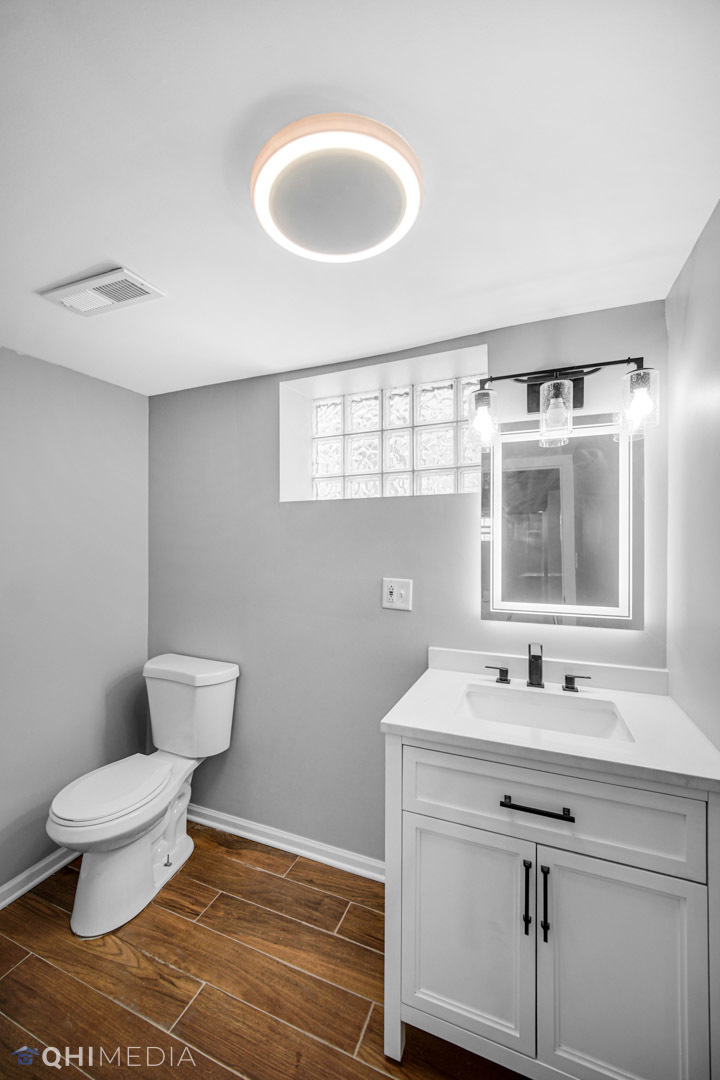 14601 Des Plaines Street Harvey, IL 60426 - Photo 13 of 21 a bathroom with a sink toilet and mirror