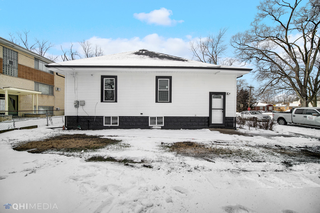 14601 Des Plaines Street Harvey, IL 60426 - Photo 19 of 21 a view of a house with a yard covered in snow