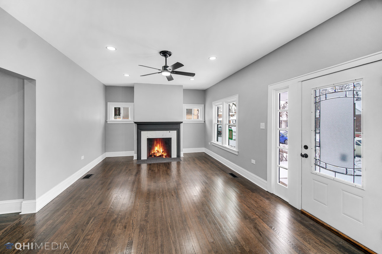 14601 Des Plaines Street Harvey, IL 60426 - Photo 4 of 21 a view of an empty room with a fireplace and a window
