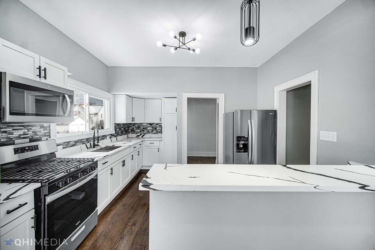 14601 Des Plaines Street Harvey, IL 60426 - Photo 8 of 21 a kitchen with stainless steel appliances kitchen island granite countertop a sink stove and refrigerator
