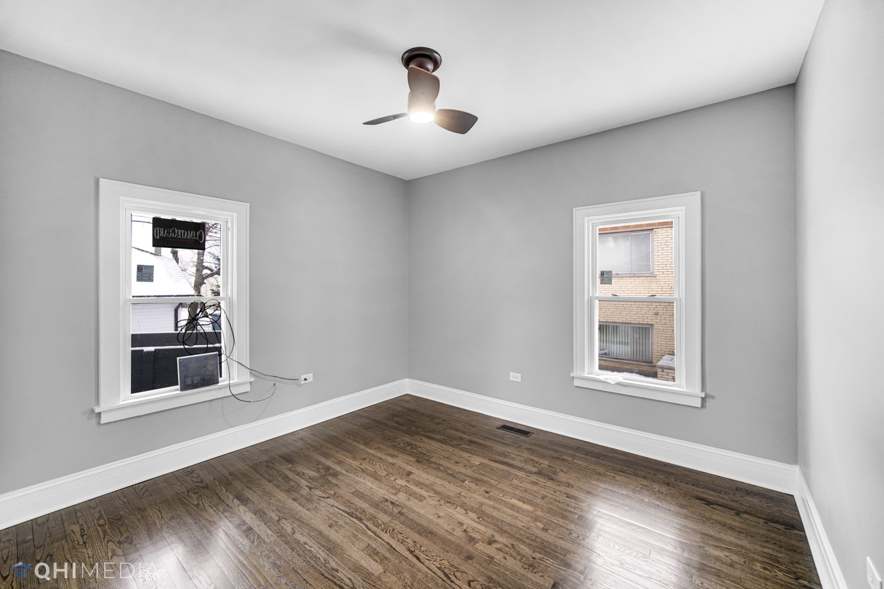14601 Des Plaines Street Harvey, IL 60426 - Photo 9 of 21 a view of empty room with wooden floor and fan
