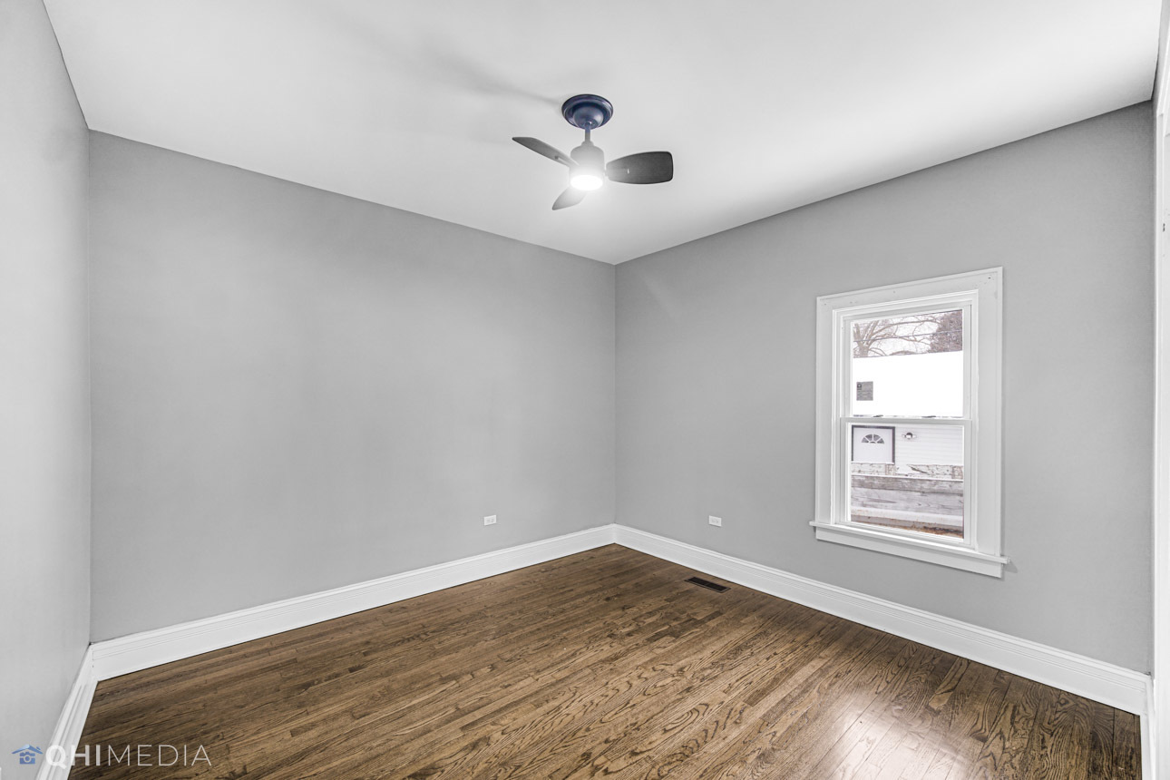 14601 Des Plaines Street Harvey, IL 60426 - Photo 10 of 21 a view of an empty room with wooden floor and a window