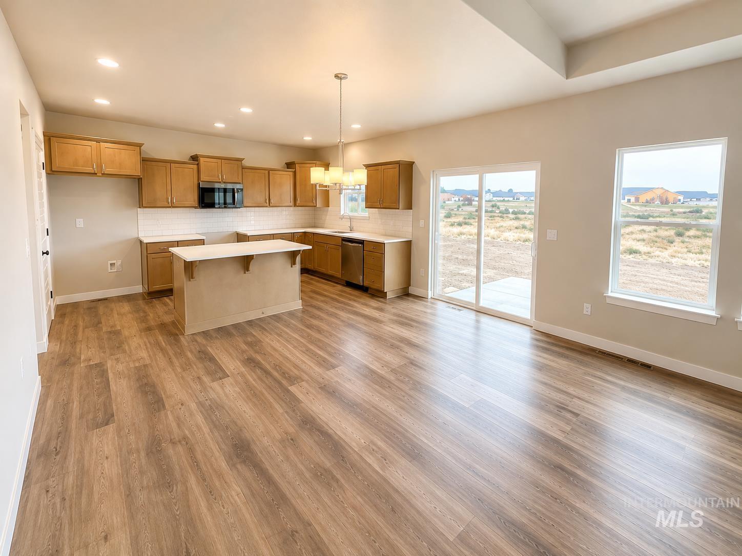 983 Quartz Road Kimberly, ID 83341 - Photo 4 of 18 Wood-finish flooring, recessed lighting, and a kitchen island with seating