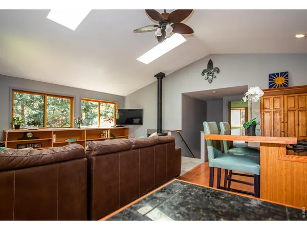 a living room with furniture a window and a flat screen tv