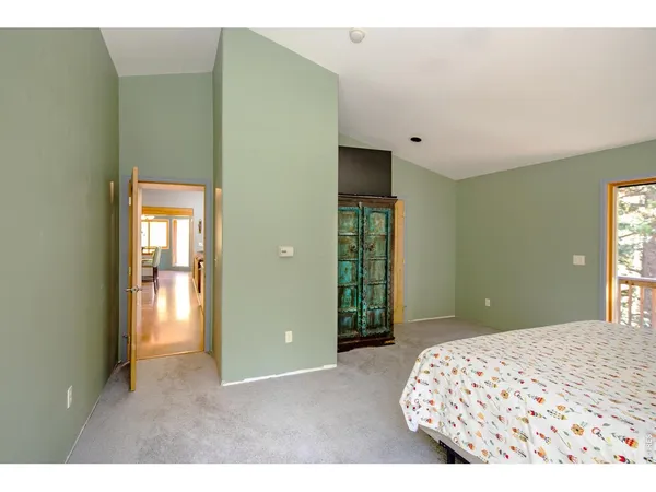 a bedroom with a bed and a lamp