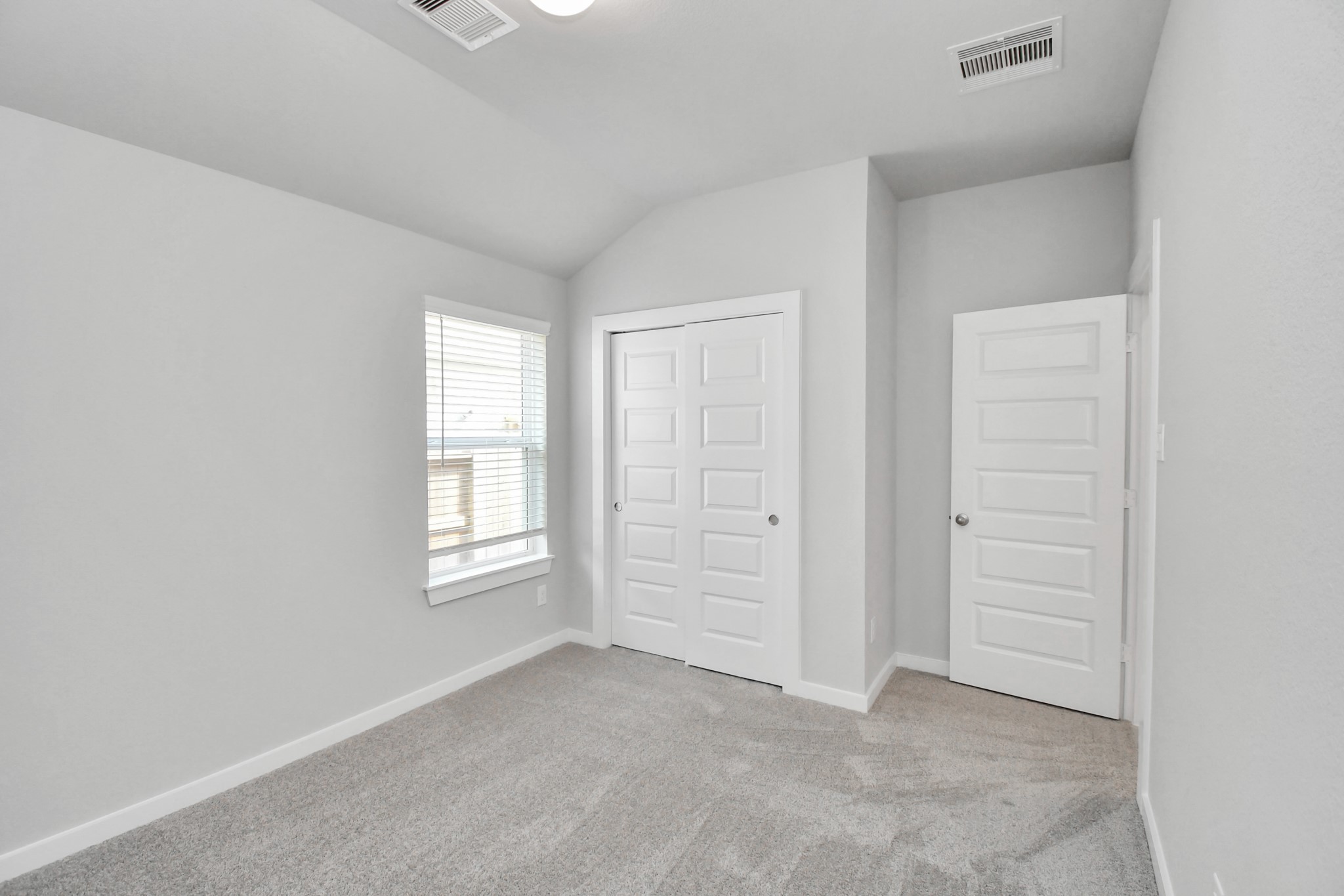 24611 Broad Park Spring, TX 77373 - Photo 22 of 25 Generously sized secondary bedrooms featuring spacious closets, soft and inviting carpeting underfoot, large windows allowing plenty of natural light, and the added touch of privacy blinds for your personal retreat. Sample photo of completed home with similar floor plan. Actual colors and selections may vary.