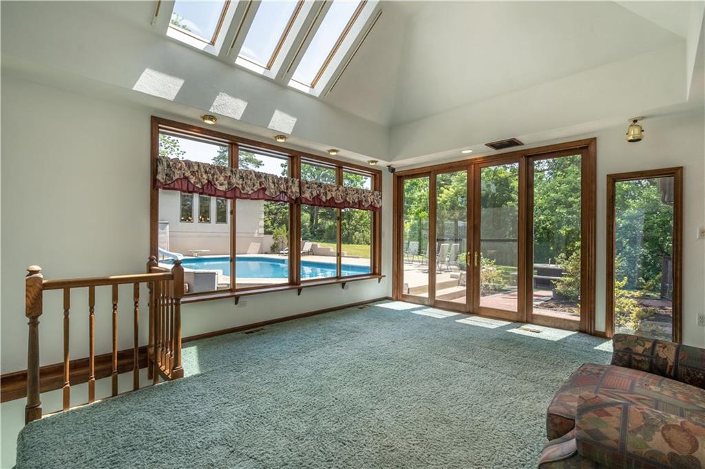 115 Center Church Road Canonsburg, PA 15317 - Photo 8 of 25 Family Room:This million dollar view is free! Custom designed skylights with splayed shaft ceiling. Ceiling height 12.8. Four paneled sliding doors 10 ft wide and 8 ft high. Sky lights are vented and ceiling fan has remote control. On the left is one of the staircases to lower level.
