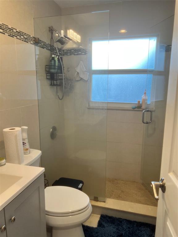 1410 Northeast 56th Court, Unit 1410 Fort Lauderdale, FL 33334 - Photo 9 of 14 a bathroom with a sink a toilet and shower