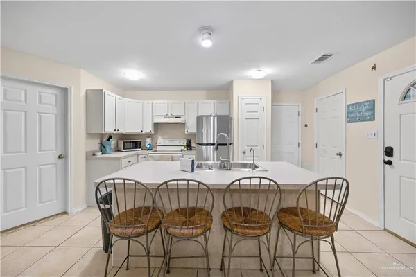 a view of kitchen and dining area with chandelier