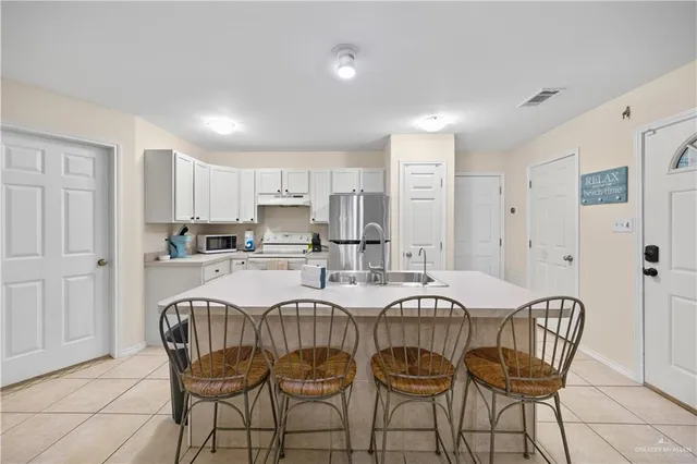 a view of kitchen and dining area with chandelier