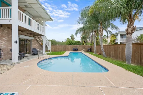 a view of outdoor space with swimming pool and seating