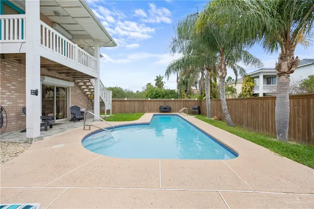 a view of outdoor space with swimming pool and seating