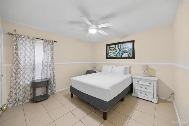 a spacious bedroom with a bed and a table in it