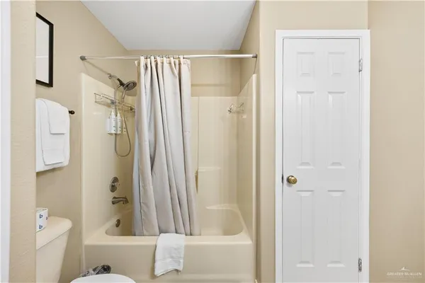 a bathroom with a shower and a glass door