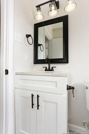 a bathroom with a sink vanity and a mirror