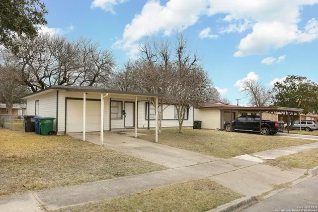 front view of a house with a patio and a yard
