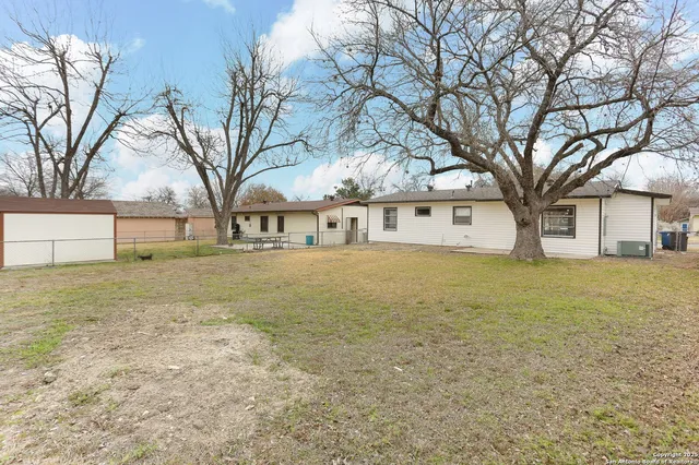 a view of large yard with large trees