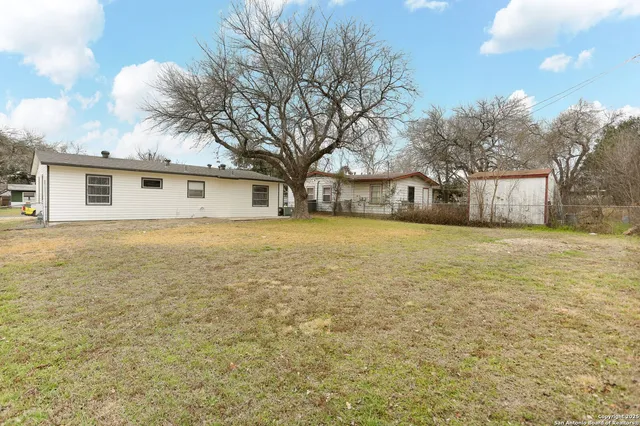 a front view of house with yard and trees