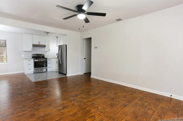 a view of a kitchen with a stove cabinets and wooden floor