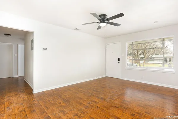 a view of a big room with wooden floor closet and windows