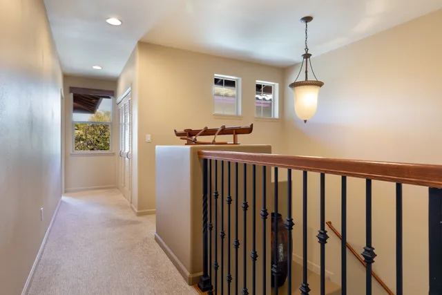 a view of hallway with wooden floor
