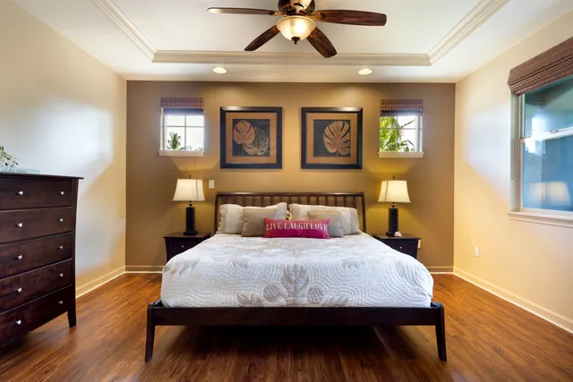 a bedroom with a bed and wooden floor