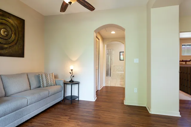 a view of living room filled with furniture and wooden floor