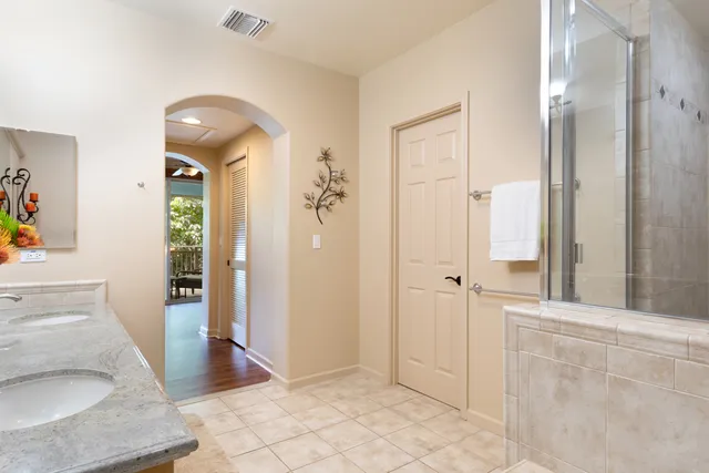 a bathroom with a sink and glass door shower