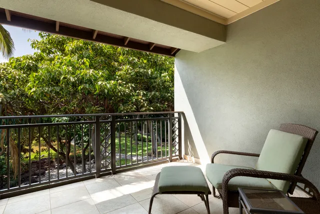 a view of a chair and table in the balcony