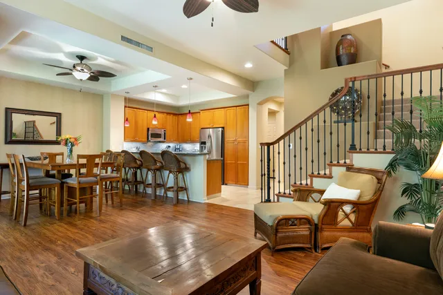 a living room with lots of furniture and a view of dining room